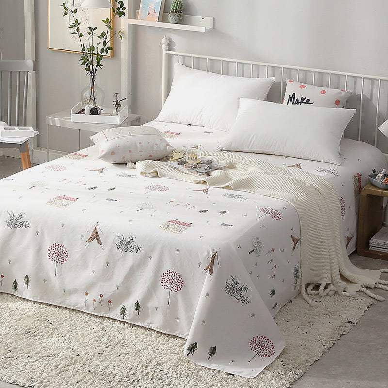 Cozy bed with soft cotton printed sheets in neutral bedroom setting
