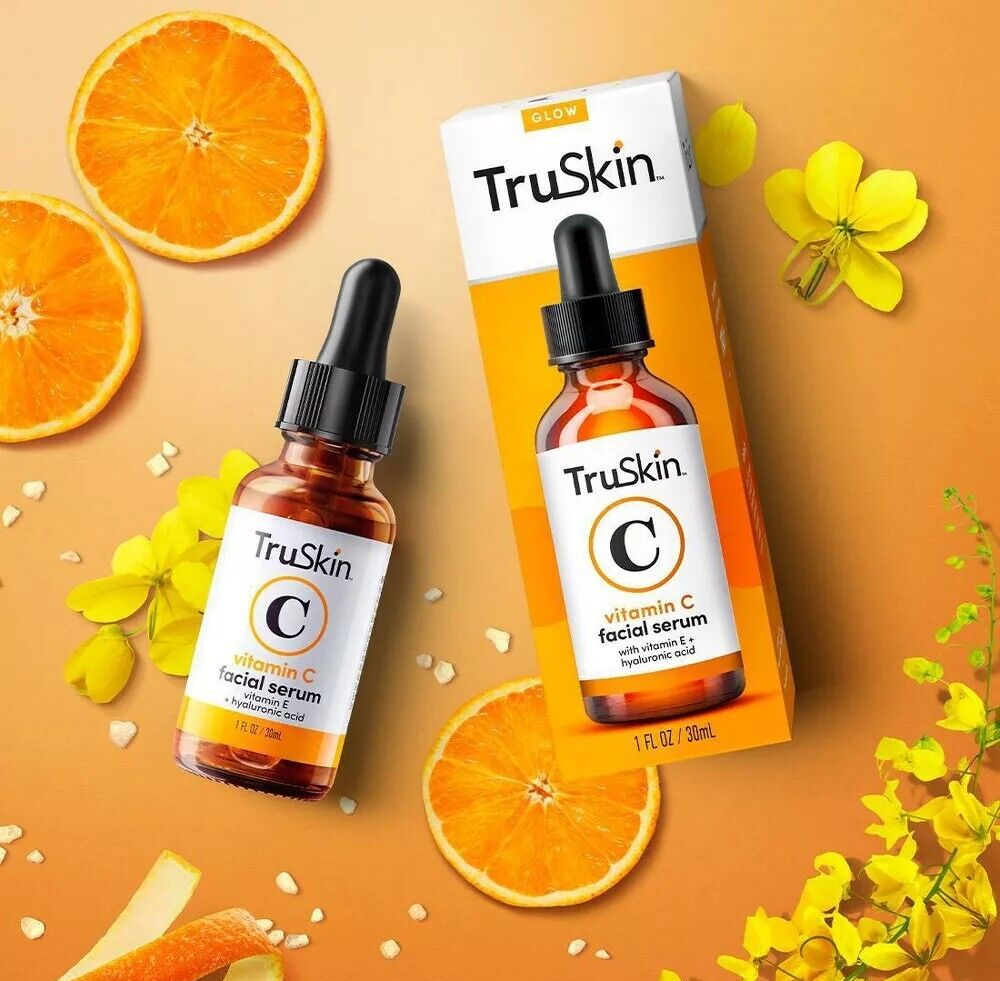 TruSkin Vitamin C Serum Anti Aging Face Serum with Hyaluronic Acid 30ml bottle and box with oranges and yellow flowers on orange background